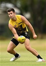 GOLD COAST, AUSTRALIA - OCTOBER 22: Trent Cotchin of the Tigers handballs during a Richmond Tigers AFL training session at Metricon Stadium on October 22, 2020 in Gold Coast, Australia. (Photo by Quinn Rooney/Getty Images)