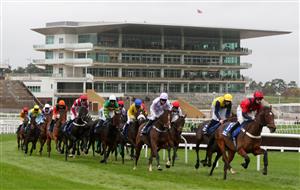 CHELTENHAM, ENGLAND - OCTOBER 24: Runner and riders go round a bend in front of empty stands during the Pertemps Network Handicap Hurdle at Cheltenham Racecourse on October 24, 2020 in Cheltenham, England. (Photo by David Davies - Pool / Getty Images)