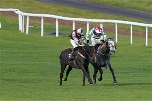CHEPSTOW, WALES - OCTOBER 27: Charlie Price riding Spectator (maroon) clear the last to win The Wizard Of Big Odds At tipstersempire.co.uk Handicap Hurdle at Chepstow Racecourse on October 27, 2020 in Chepstow, Wales. Owners are allowed to attend if they have a runner at the meeting otherwise racing remains behind closed doors to the public due to the Coronavirus pandemic. (Photo by Alan Crowhurst/Getty Images)