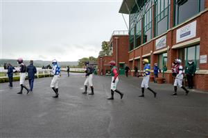 TAUNTON, ENGLAND - OCTOBER 28: A general view as jockeys make their way to the parade ring at Taunton Racecourse on October 28, 2020 in Taunton, England. Owners are allowed to attend if they have a runner at the meeting otherwise racing remains behind closed doors to the public due to the Coronavirus pandemic. (Photo by Alan Crowhurst/Getty Images)