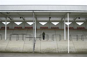 WETHERBY, ENGLAND - OCTOBER 30: A lone person watches the action from the stands at Wetherby Racecourse on October 30, 2020 in Wetherby, England. (Photo by Tim Goode - Pool/Getty Images)