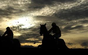 WETHERBY, ENGLAND - OCTOBER 30: Runners and riders silhouetted as they clear a fence in the Each Way Extra At bet365 Handicap Chase at Wetherby Racecourse on October 30, 2020 in Wetherby, England. (Photo by Tim Goode - Pool/Getty Images)