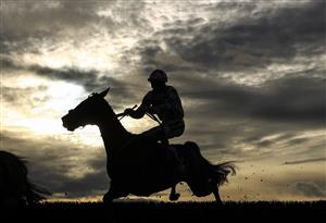 WETHERBY, ENGLAND - OCTOBER 30: Runners and riders silhouetted as they clear a fence in the Each Way Extra At bet365 Handicap Chase at Wetherby Racecourse on October 30, 2020 in Wetherby, England. (Photo by Tim Goode - Pool/Getty Images)
