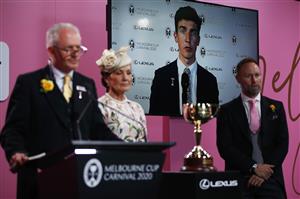 MELBOURNE, AUSTRALIA - NOVEMBER 03: VRC Melbourne Cup Tour Manager Joe McGrath (L), VRC Chairman Amanda Elliott and Lexus CEO Scott Thompson (R) present the trophy to Mark Power (via link) after winning race 7 the Lexus Melbourne Cup during 2020 Lexus Melbourne Cup Day at Flemington Racecourse on November 03, 2020 in Melbourne, Australia. (Photo by Daniel Pockett/Getty Images for the VRC)