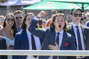 SYDNEY, AUSTRALIA - NOVEMBER 03: Racegoers cheer as they watch the Melbourne Cup on the big screen during Bentley Cup Day at Royal Randwick Racecourse on November 03, 2020 in Sydney, Australia. The Melbourne Cup is Australia