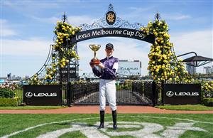 This handout photo taken and released on November 3, 2020 by Racing Photos shows Jye McNeil, who rode Twilight Payment of Ireland, celebrating with the trophy after winning the Melbourne Cup at Flemington Racecourse in Melbourne. (Photo by Scott Barbour / RACING PHOTOS / AFP) / XGTY / EDITORS NOTE ----RESTRICTED TO EDITORIAL USE MANDATORY CREDIT " AFP PHOTO /SCOTT BARBOUR / RACING PHOTOS" NO MARKETING NO ADVERTISING CAMPAIGNS - DISTRIBUTED AS A SERVICE TO CLIENTS - NO ARCHIVES (Photo by SCOTT BARBOUR/RACING PHOTOS/AFP via Getty Images)