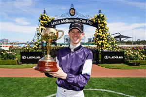 This handout photo taken and released on November 3, 2020 by Racing Photos shows Jye McNeil, who rode Twilight Payment of Ireland, celebrating with the trophy after winning the Melbourne Cup at Flemington Racecourse in Melbourne. (Photo by Scott Barbour / RACING PHOTOS / AFP) / XGTY / EDITORS NOTE ----RESTRICTED TO EDITORIAL USE MANDATORY CREDIT " AFP PHOTO /SCOTT BARBOUR / RACING PHOTOS" NO MARKETING NO ADVERTISING CAMPAIGNS - DISTRIBUTED AS A SERVICE TO CLIENTS - NO ARCHIVES (Photo by SCOTT BARBOUR/RACING PHOTOS/AFP via Getty Images)