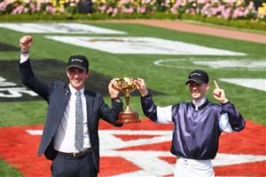 MELBOURNE, AUSTRALIA - NOVEMBER 03: Jockey Jye McNeil and travelling foreman Mark Power pose with the 2020 Melbourne Cup after riding #6 Twilight Payment to victory in Race 7, the Lexus Melbourne Cup during Melbourne Cup Day at Flemington Racecourse on November 03, 2020 in Melbourne, Australia. (Photo by Vince Caligiuri/Getty Images for the VRC)
