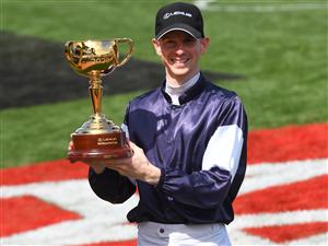 MELBOURNE, AUSTRALIA - NOVEMBER 03: Jockey Jye McNeil poses with the 2020 Melbourne Cup after riding #6 Twilight Payment to victory in Race 7, the Lexus Melbourne Cup during Melbourne Cup Day at Flemington Racecourse on November 03, 2020 in Melbourne, Australia. (Photo by Vince Caligiuri/Getty Images for the VRC)