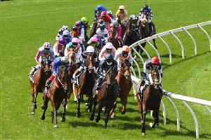 MELBOURNE, AUSTRALIA - NOVEMBER 03: Jye McNeil riding Twilight Payment leads the field around the first bend in the Lexus Melbourne Cup during 2020 Lexus Melbourne Cup Day at Flemington Racecourse on November 03, 2020 in Melbourne, Australia. (Photo by Quinn Rooney/Getty Images for the VRC)