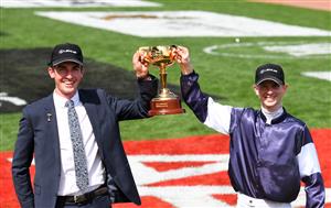 MELBOURNE, AUSTRALIA - NOVEMBER 03: Jockey Jye McNeil and travelling foreman Mark Power pose with the 2020 Melbourne Cup after riding #6 Twilight Payment to victory in Race 7, the Lexus Melbourne Cup during Melbourne Cup Day at Flemington Racecourse on November 03, 2020 in Melbourne, Australia. (Photo by Vince Caligiuri/Getty Images for the VRC)