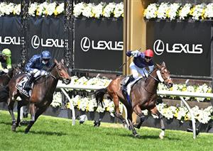 MELBOURNE, AUSTRALIA - NOVEMBER 03: Jockey Jye McNeil riding Twilight Payment defeats Jockey Kerrin McEvoy riding Tiger Moth to win Race 7, the Lexus Melbourne Cup, during 2020 Lexus Melbourne Cup Day at Flemington Racecourse on November 03, 2020 in Melbourne, Australia. (Photo by Vince Caligiuri/Getty Images for the VRC)