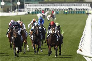 MELBOURNE, AUSTRALIA - NOVEMBER 03: Jye McNiel rides Twilight Payment to win race 7 the Lexus Melbourne Cup as Hugh Bowman pulls up on Anthony Van Dyck in the background during 2020 Lexus Melbourne Cup Day at Flemington Racecourse on November 03, 2020 in Melbourne, Australia. (Photo by Darrian Traynor/Getty Images for the VRC)