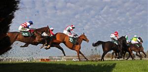 WARWICK, ENGLAND - NOVEMBER 06: Runners and riders jump a fence on the first lap during the racingtv.com Novices' Hurdle at Warwick Racecourse on November 6, 2020 in Warwick, England. (Photo by David Davies - Pool / Getty Images)