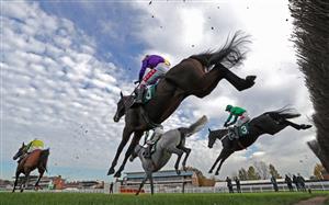 WARWICK, ENGLAND - NOVEMBER 06: Runners and riders jump a fence on the first lap during the Stan Mellor Memorial Novices Chase at Warwick Racecourse on November 6, 2020 in Warwick, England. (Photo by David Davies - Pool / Getty Images)
