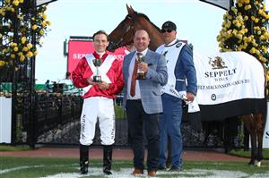 MELBOURNE, AUSTRALIA - NOVEMBER 07: Jockey Luke Currie and trainer Grant Williams pose with the winners trophy following #9 Arcadia Queen