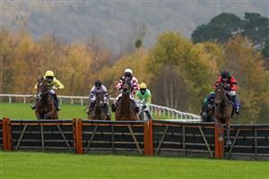 TAUNTON, ENGLAND - NOVEMBER 12: Harry Skelton riding Aggy With It (red) clear the last to win The Newton King Estate Agents Novices' Hurdle at Taunton Racecourse on November 12, 2020 in Taunton, England. Owners are allowed to attend if they have a runner at the meeting otherwise racing remains behind closed doors to the public due to the Coronavirus pandemic. (Photo by Alan Crowhurst/Getty Images)