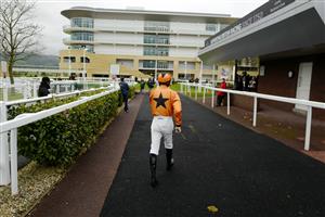 CHELTENHAM, ENGLAND - NOVEMBER 14: A general view as a jockey makes his way to the parade ring at Cheltenham Racecourse on November 14, 2020 in Cheltenham, England. Owners are allowed to attend if they have a runner at the meeting otherwise racing remains behind closed doors to the public due to the Coronavirus pandemic. (Photo by Alan Crowhurst/Getty Images)