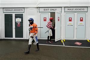 CHELTENHAM, ENGLAND - NOVEMBER 14: A general view as jockeys leave the temporary changinig room for the parade ring at Cheltenham Racecourse on November 14, 2020 in Cheltenham, England. Owners are allowed to attend if they have a runner at the meeting otherwise racing remains behind closed doors to the public due to the Coronavirus pandemic. (Photo by Alan Crowhurst/Getty Images)