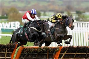 CHELTENHAM, ENGLAND - NOVEMBER 14: Nico de Boinville riding On The Blind Side (red) clear the last to win The Paddy Power Games Handicap Hurdle at Cheltenham Racecourse on November 14, 2020 in Cheltenham, England. Owners are allowed to attend if they have a runner at the meeting otherwise racing remains behind closed doors to the public due to the Coronavirus pandemic. (Photo by Alan Crowhurst/Getty Images)