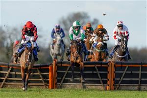WINCANTON, ENGLAND - NOVEMBER 19: Jonjo O'Neill Jr riding Cary's Commodity (pink/green) clear the last to win The Join Racing TV Now Handicap Hurdle at Wincanton Racecourse on November 19, 2020 in Wincanton, England. Owners are allowed to attend if they have a runner at the meeting otherwise racing remains behind closed doors to the public due to the Coronavirus pandemic. (Photo by Alan Crowhurst/Getty Images)