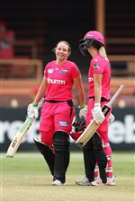 SYDNEY, AUSTRALIA - NOVEMBER 22: Alyssa Healy of the Sixers celebrates scoring a century with team mate Ellyse Perry of the Sixers during the Women's Big Bash League WBBL match between the Melbourne Stars and the Sydney Sixers at North Sydney Oval, on November 22, 2020, in Sydney, Australia. (Photo by Cameron Spencer/Getty Images)