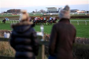 WETHERBY, UNITED KINGDOM - NOVEMBER 25: Spectators outside the course grounds watch the runners and riders in the EBF Stallions Mares' Standard Open National Hunt Flat Race (GBB Race) at Wetherby Racecourse on November 25, 2020 in Wetherby, England. (Photo by Mike Egerton - Pool/Getty Images)