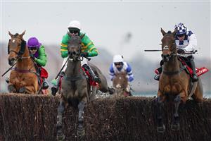 NEWBURY, ENGLAND - NOVEMBER 27: Jonathan Burke riding Clondaw Castle (check) clear the last to win The Get Your Ladbrokes 1 Free Bet Today Handicap Chase at Newbury Racecourse on November 27, 2020 in Newbury, England. Owners are allowed to attend if they have a runner at the meeting otherwise racing remains behind closed doors to the public due to the Coronavirus pandemic. (Photo by Alan Crowhurst/Getty Images)