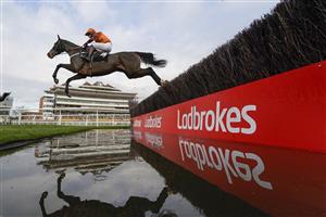NEWBURY, ENGLAND - NOVEMBER 27: Sam Waley-Cohen riding Elusive Belle clear the water jump before going on to win The Ladbrokes Daily Odds Boosts Chase at Newbury Racecourse on November 27, 2020 in Newbury, England. Owners are allowed to attend if they have a runner at the meeting otherwise racing remains behind closed doors to the public due to the Coronavirus pandemic. (Photo by Alan Crowhurst/Getty Images)