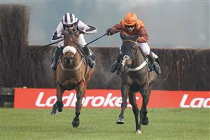 NEWBURY, ENGLAND - NOVEMBER 27: Sam Waley-Cohen riding Elusive Belle (orange/brown) clear the last to win The Ladbrokes Daily Odds Boosts Chase at Newbury Racecourse on November 27, 2020 in Newbury, England. Owners are allowed to attend if they have a runner at the meeting otherwise racing remains behind closed doors to the public due to the Coronavirus pandemic. (Photo by Alan Crowhurst/Getty Images)
