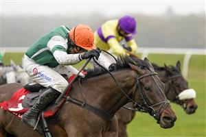 NEWBURY, ENGLAND - NOVEMBER 28: Harry Skelton riding Flash The Steel (orange cap) clear the last to win The Get Your Ladbrokes 1 Free Bet Today Handicap Hurdle at Newbury Racecourse on November 28, 2020 in Newbury, England. Owners are allowed to attend if they have a runner at the meeting otherwise racing remains behind closed doors to the public due to the Coronavirus pandemic. (Photo by Alan Crowhurst/Getty Images)