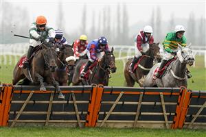 NEWBURY, ENGLAND - NOVEMBER 28: Harry Skelton riding Flash The Steel (orange cap) clear the last to win The Get Your Ladbrokes 1 Free Bet Today Handicap Hurdle at Newbury Racecourse on November 28, 2020 in Newbury, England. Owners are allowed to attend if they have a runner at the meeting otherwise racing remains behind closed doors to the public due to the Coronavirus pandemic. (Photo by Alan Crowhurst/Getty Images)