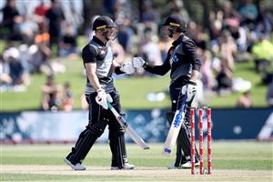 TAURANGA, NEW ZEALAND - NOVEMBER 29: Glenn Phillips of New Zealand (L) celebrates his century with Devon Conway of New Zealand (R) during game two of the International Twenty20 series between New Zealand and the West Indies at Bay Oval on November 29, 2020 in Tauranga, New Zealand. (Photo by Phil Walter/Getty Images)