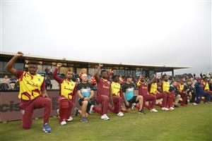 TAURANGA, NEW ZEALAND - NOVEMBER 30: New Zealand and West Indies players and staff raise their hands in support of the Black Lives Matter movement during game three of the International Twenty20 series between New Zealand and the West Indies at Bay Oval on November 30, 2020 in Tauranga, New Zealand. (Photo by Phil Walter/Getty Images)