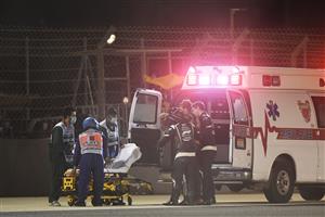 BAHRAIN, BAHRAIN - NOVEMBER 29: Romain Grosjean of France and Haas F1 is pictured being helped into an ambulance after a crash during the F1 Grand Prix of Bahrain at Bahrain International Circuit on November 29, 2020 in Bahrain, Bahrain. (Photo by Rudy Carezzevoli/Getty Images)