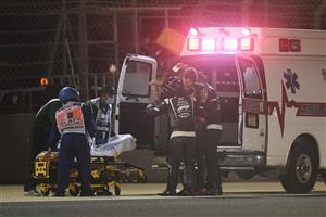 BAHRAIN, BAHRAIN - NOVEMBER 29: Romain Grosjean of France and Haas F1 is pictured being helped into an ambulance after a crash during the F1 Grand Prix of Bahrain at Bahrain International Circuit on November 29, 2020 in Bahrain, Bahrain. (Photo by Rudy Carezzevoli/Getty Images)