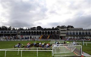 LUDLOW, ENGLAND - DECEMBER 02: Racegoers in the grand stand watch the action from the Sir Toby Memorial Novices' Handicap Chase at Ludlow Racecourse on December 2, 2020 in Ludlow, England. (Photo by David Davies - Pool/Getty Images)