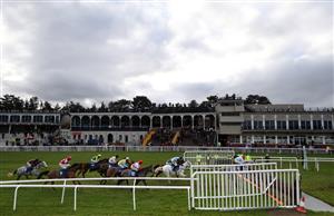 LUDLOW, ENGLAND - DECEMBER 02: Racegoers in the grand stand watch the action from the Sir Toby Memorial Novices' Handicap Chase at Ludlow Racecourse on December 2, 2020 in Ludlow, England. (Photo by David Davies - Pool/Getty Images)