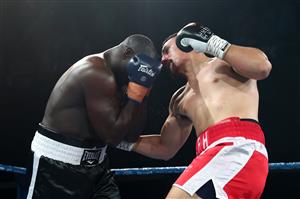 BRISBANE, AUSTRALIA - DECEMBER 03: Justis Huni punches Arsene Fosso during the Australian Heavyweight Title fight at Fortitude Music Hall on December 03, 2020 in Brisbane, Australia. (Photo by Chris Hyde/Getty Images)