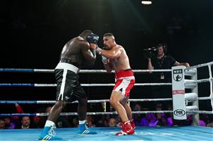 BRISBANE, AUSTRALIA - DECEMBER 03: Justis Huni punches Arsene Fosso during the Australian Heavyweight Title fight at Fortitude Music Hall on December 03, 2020 in Brisbane, Australia. (Photo by Chris Hyde/Getty Images)