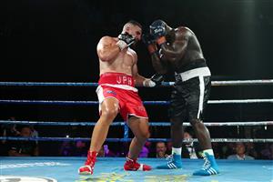 BRISBANE, AUSTRALIA - DECEMBER 03: Justis Huni punches Arsene Fosso during the Australian Heavyweight Title fight at Fortitude Music Hall on December 03, 2020 in Brisbane, Australia. (Photo by Chris Hyde/Getty Images)