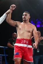 BRISBANE, AUSTRALIA - DECEMBER 03: Justis Huni celebrates winning aginst Arsene Fosso during the Australian Heavyweight Title fight at Fortitude Music Hall on December 03, 2020 in Brisbane, Australia. (Photo by Chris Hyde/Getty Images)