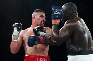 BRISBANE, AUSTRALIA - DECEMBER 03: Justis Huni punches Arsene Fosso during the Australian Heavyweight Title fight at Fortitude Music Hall on December 03, 2020 in Brisbane, Australia. (Photo by Chris Hyde/Getty Images)