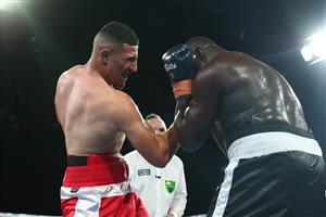BRISBANE, AUSTRALIA - DECEMBER 03: Justis Huni punches Arsene Fosso during the Australian Heavyweight Title fight at Fortitude Music Hall on December 03, 2020 in Brisbane, Australia. (Photo by Chris Hyde/Getty Images)