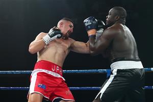 BRISBANE, AUSTRALIA - DECEMBER 03: Justis Huni punches Arsene Fosso during the Australian Heavyweight Title fight at Fortitude Music Hall on December 03, 2020 in Brisbane, Australia. (Photo by Chris Hyde/Getty Images)