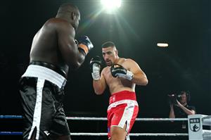 BRISBANE, AUSTRALIA - DECEMBER 03: Justis Huni punches Arsene Fosso during the Australian Heavyweight Title fight at Fortitude Music Hall on December 03, 2020 in Brisbane, Australia. (Photo by Chris Hyde/Getty Images)