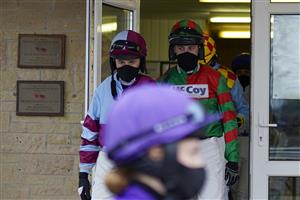 WINCANTON, ENGLAND - DECEMBER 03: A general view as the jockeys leave the weighing room at Wincanton Racecourse on December 03, 2020 in Wincanton, England. Owners and a limited number of the public are allowed to attend the meeting due to the Coronavirus pandemic. (Photo by Alan Crowhurst/Getty Images)