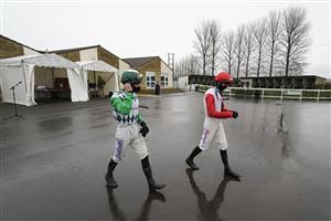 WINCANTON, ENGLAND - DECEMBER 03: Jockeys make their way to the parade ring at Wincanton Racecourse on December 03, 2020 in Wincanton, England. Owners and a limited number of the public are allowed to attend the meeting due to the Coronavirus pandemic. (Photo by Alan Crowhurst/Getty Images)