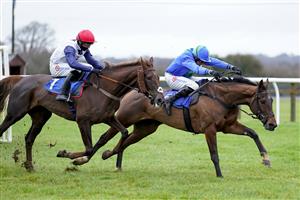 WINCANTON, ENGLAND - DECEMBER 03: Harry Skelton riding Global Harmony (R) clear the last to win The Watch Racing TV In Stunning HD Mares' Novices' Hurdle at Wincanton Racecourse on December 03, 2020 in Wincanton, England. Owners and a limited number of the public are allowed to attend the meeting due to the Coronavirus pandemic. (Photo by Alan Crowhurst/Getty Images)
