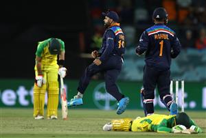 CANBERRA, AUSTRALIA - DECEMBER 02: Virat Kohli of India celebrates after running out Alex Carey of Australia during game three of the One Day International series between Australia and India at Manuka Oval on December 02, 2020 in Canberra, Australia. (Photo by Ryan Pierse/Getty Images)